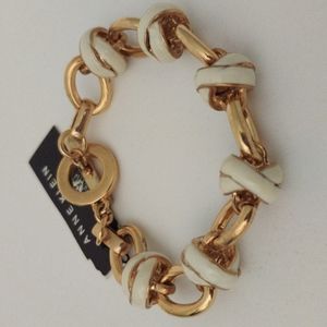 Anne Klein cream enamel x and o gold metal link bracelet